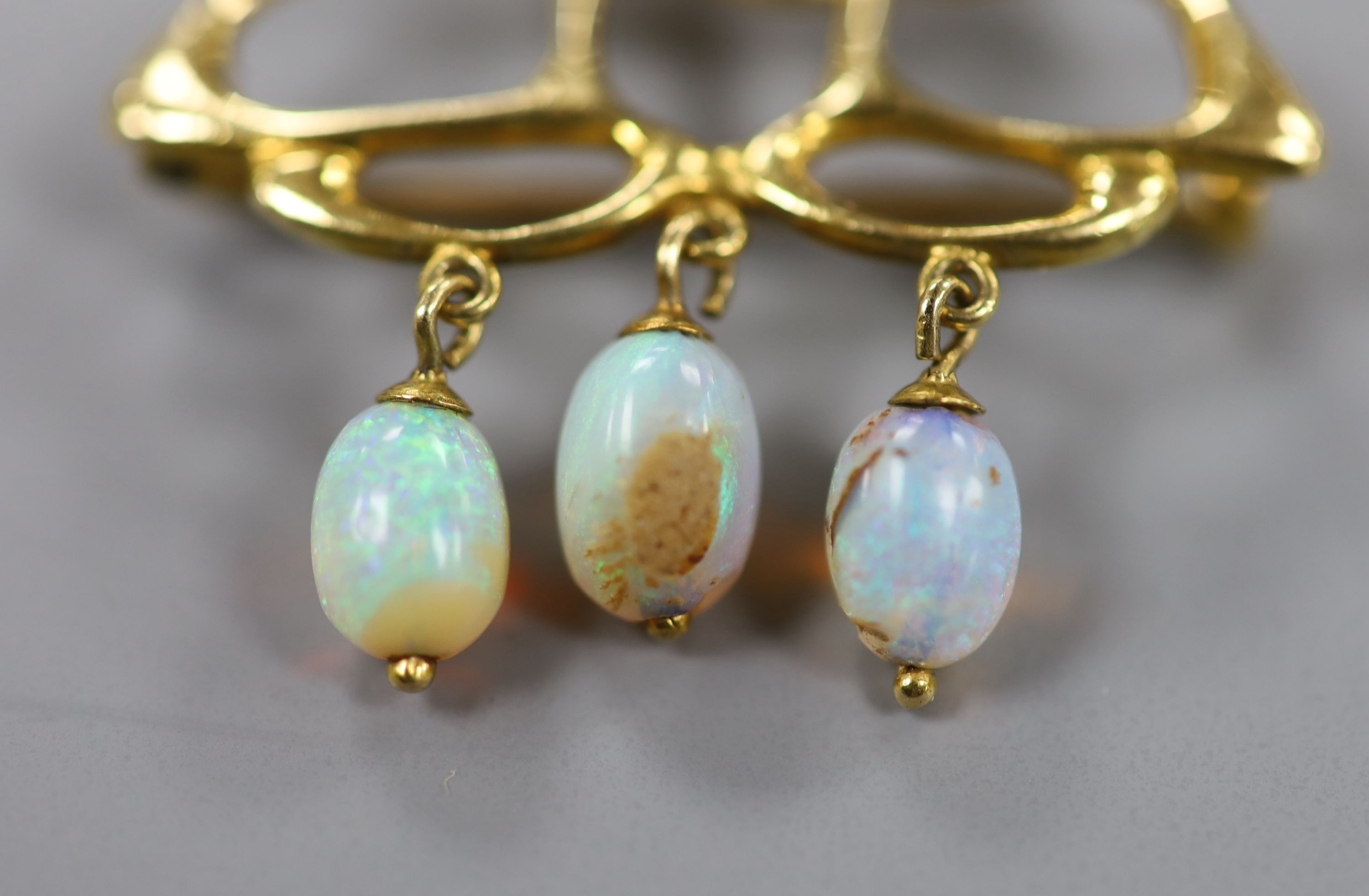 A stylish Art Nouveau yellow metal and five stone opal set brooch(a.f.), 31mm, gross weight 4.8 grams.